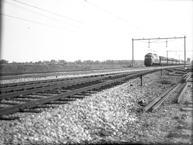 804206 Gezicht op de spoorlijn te Nieuwersluis, met een trein getrokken door een electrische locomotief uit de serie ...
